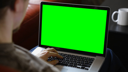 Man Using Laptop with Chroma Green Screen
