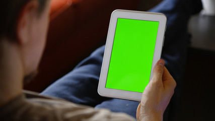 Man Using White Tablet with Chroma Green Screen