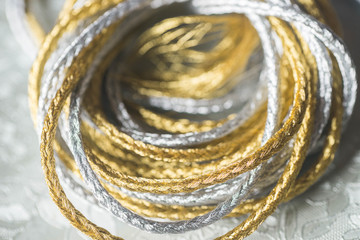 silver and gold twine on silverbackground