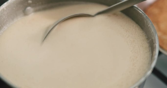 Slow motion handheld closeup checking pancakes dought