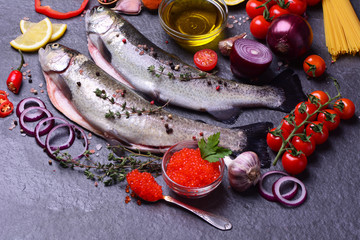Fresh rainbow trout with caviar, vegetables and spices