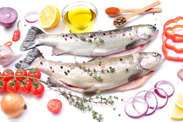 Fish trout with spices and vegetables on a white background
