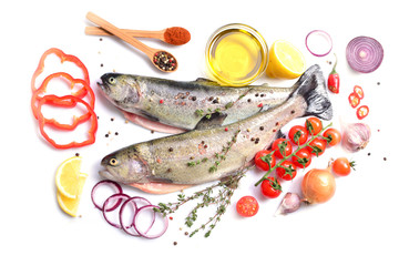 Fish trout with spices and vegetables on a white background