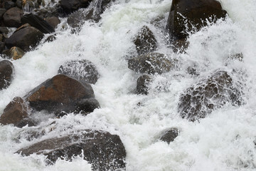 Rapid course of a mountain river. Mountain river is a river that runs usually in mountains, in narrow, deep valley with steep banks, rocky stream bed.