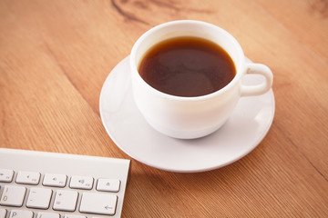office working desk top view with laptop, notepad and coffee