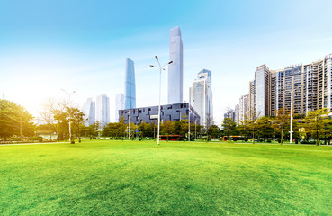 Grassy and flowery park and modern city architecture in Guangzhou, China