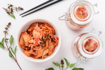 Kimchi cabbage (Korean food) in a bowl and jar, top view