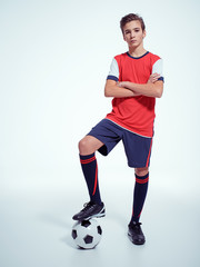 Photo of teen boy in sportswear holding soccer ball