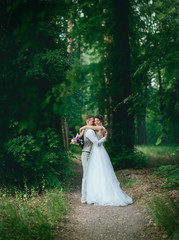 Obraz na płótnie Canvas bride and groom posing for a walk in the woods
