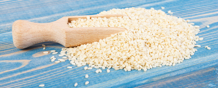 Heap of sesame seeds on wooden boards