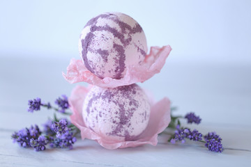 lavender bath bomb. bath bomb with lavender extract. two lilac lavender bombs and twigs of lavender flowers on gray wooden plank background. Organic Botanical Body Care