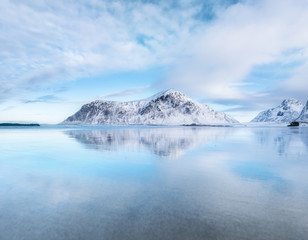 Naklejka na ściany i meble Mountain ridge and reflection on the seashore. Natural landscape in the Norway