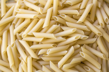 Dry pasta background, healthy food, yellow background