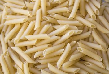Dry pasta background, healthy food, yellow background