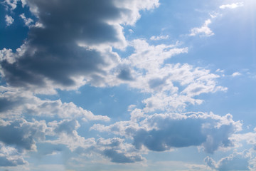 White curly clouds in a blue sky. Sky background