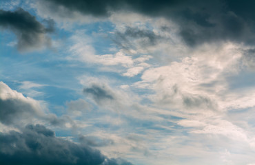 White curly clouds in a blue sky. Sky background
