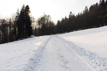 Fototapeta na wymiar Photo of snowy landscape with blue sky and road in winter