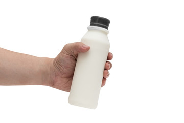 Hand holding full milk in plastic bottle isolated on white background with clipping path