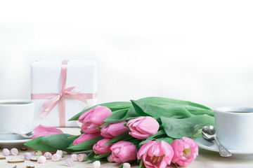 Soft romantic composition. Tulips, gifts, two cups of coffee and tender stuff