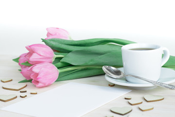 Feminine soft desktop with pink tulips, small cup of coffe and hearts