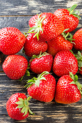Sweet and fresh strawberry on dark background. Natural food. Vertical.