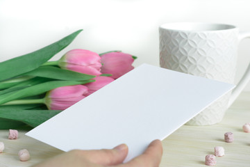 Woman's hand with postcard