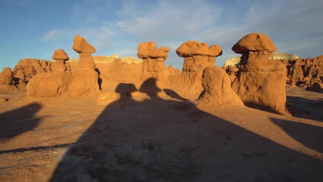 Panning the hoodoos in Goblin Valley at sunset as they glow in the light.