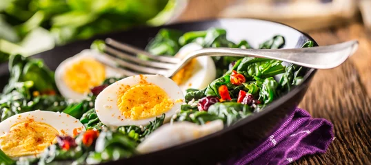 Poster Spinach Salad. Fresh spinach salad with eggs chili pepper and sweet cranberries. © weyo