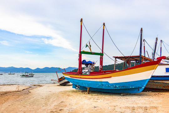 Colorful wooden fishing boat at the beach in Porto Belo.