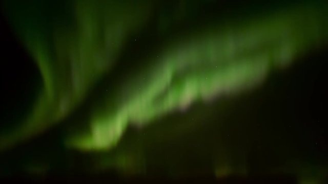 Realtime video of green purple and pink Aurora Borealis - Northern Lights, moving slowly across a starry night sky