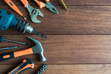 Set of work tools on wooden background