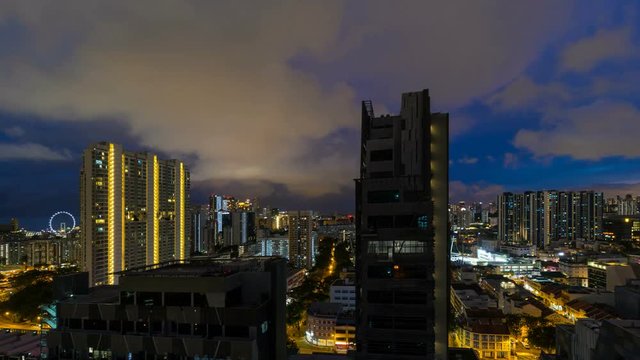 Time lapse 4k movie of fast moving clouds and sky over Bendemeer housing estate area in Singapore from sunset into blue hour into night time 3840x2160 UHD