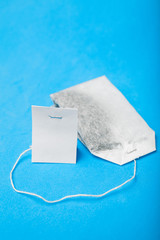An empty label with a white tea bag, selective focus. Layout.