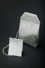 Empty tea logo and paper bag on a black background.