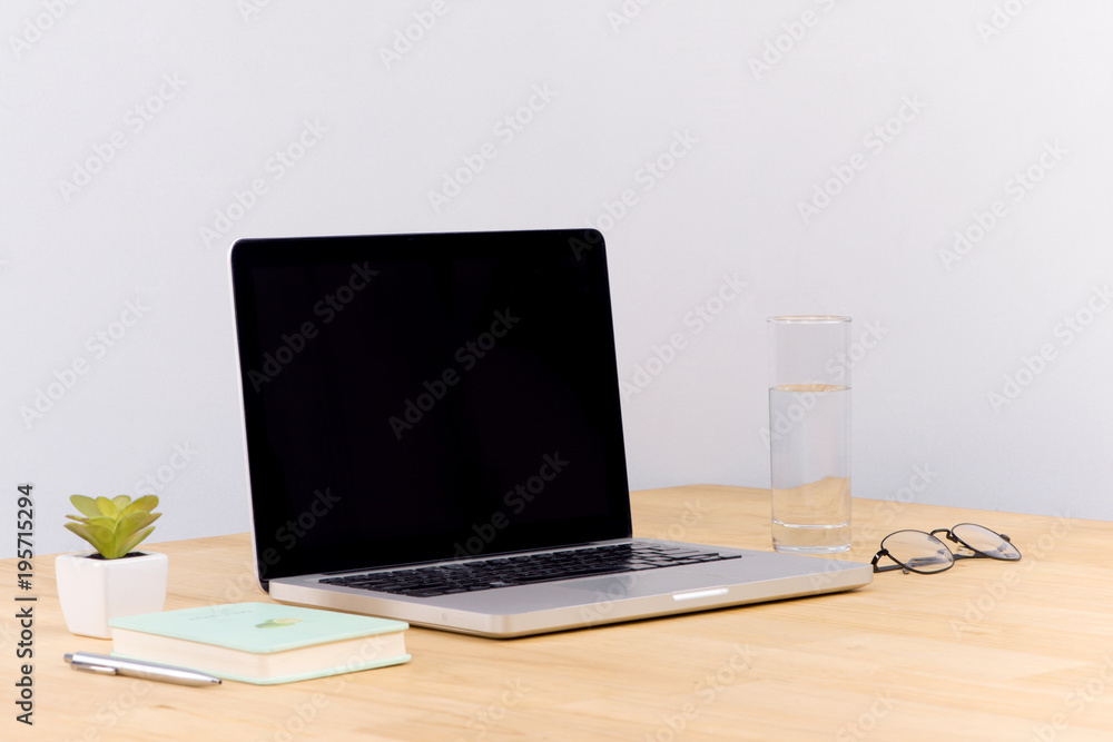 Poster laptop computer white blank screen on work table front view