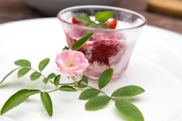 Strawberry milk and rose on wood table