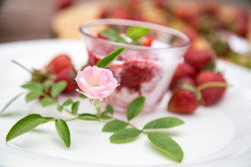 Strawberry milk and rose on wood table