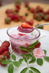 Strawberry milk and rose on wood table