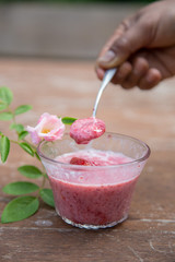 Strawberry milk and rose on wood table