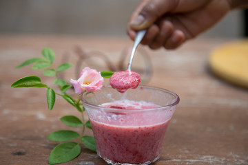 Strawberry milk and rose on wood table