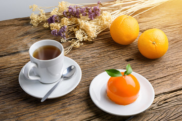 Orange cake on grunge wooden table