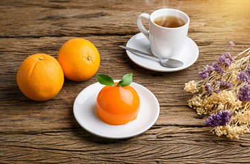 Orange cake on grunge wooden table