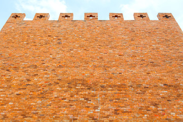 red brick wall texture on blue sky