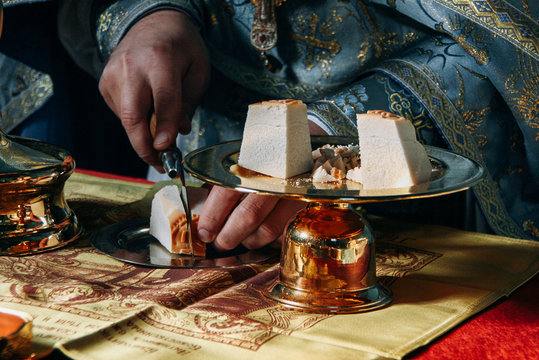 The priest cuts prosphora