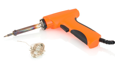 Orange pistol shaped soldering iron (tip made of copper core plated with iron)  with tin solder wire isolated on white backgroung with shadow reflection. Soldering gun with pewter solder wire.