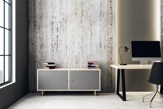 Concrete interior with workplace and cabinet