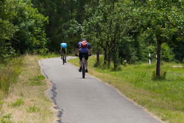 cyclists exercising on a bikeway © rudolfgeiger