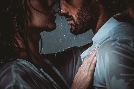 Couple sharing romantic moments under the rain
