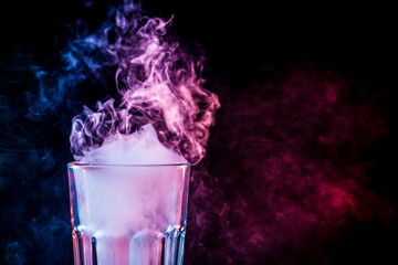 A glass with colorful smoke