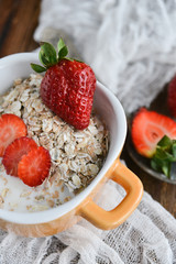 Breakfast: granola with berries fresh strawberries on wooden background natural rustic. The concept of healthy eating.